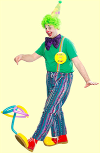 Noodles The Clown balancing balloon umbrella on foot